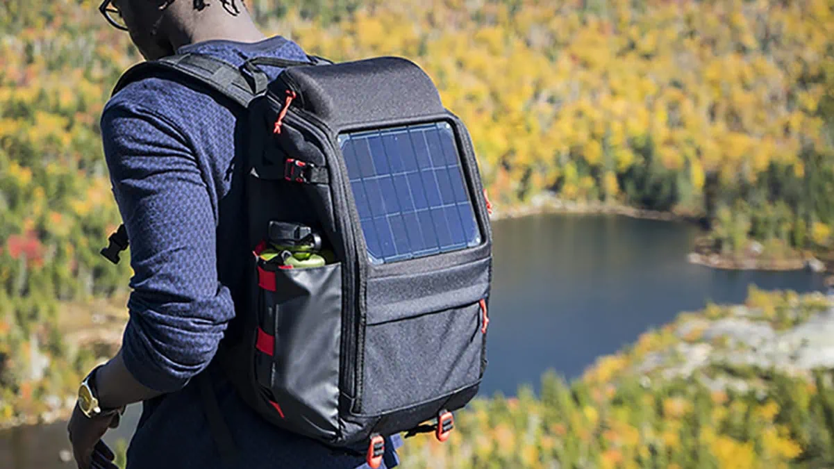 A man on a trekking trip with his solar backpack.