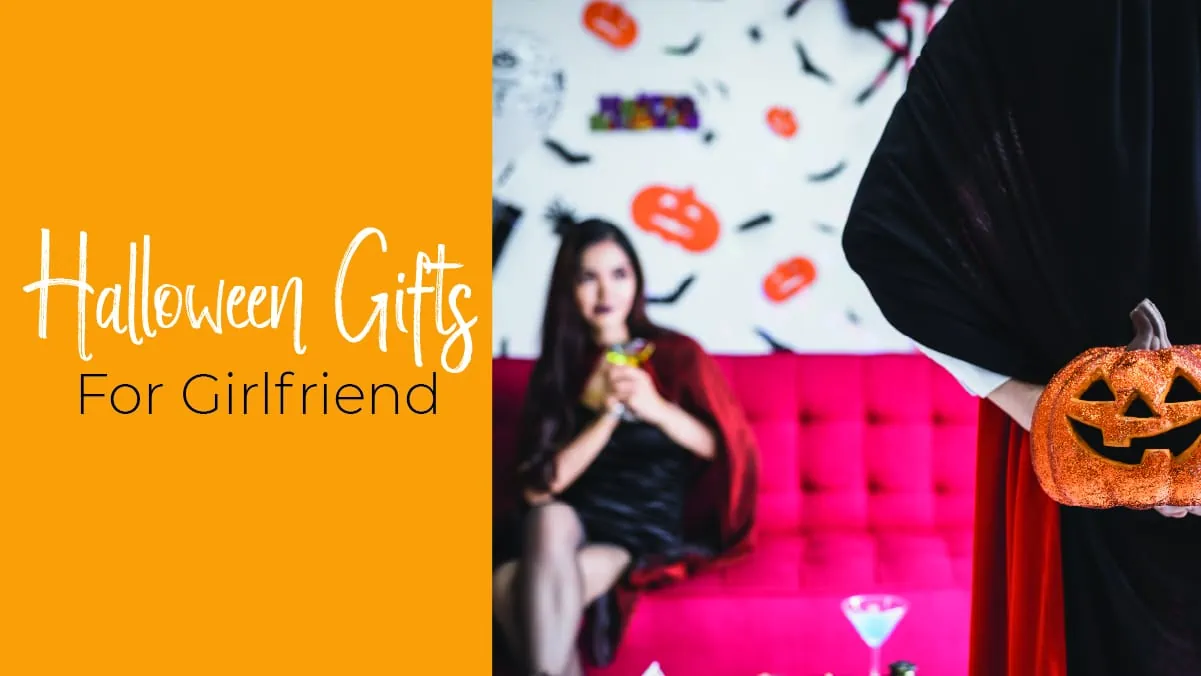 A girl dressed as a vampire is sitting at a distance on a pink couch with Halloween themed wall décor in the background. a guy wearing a vampire cape is facing the girl and is holding a glitter decorated pumpkin behind his back to surprise the girl. The text reads Halloween gifts for Girlfriend.