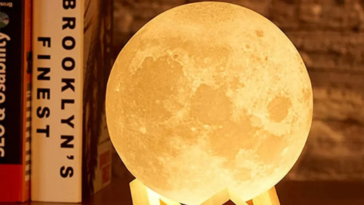 Closeup shot of a moon lamp with books behind