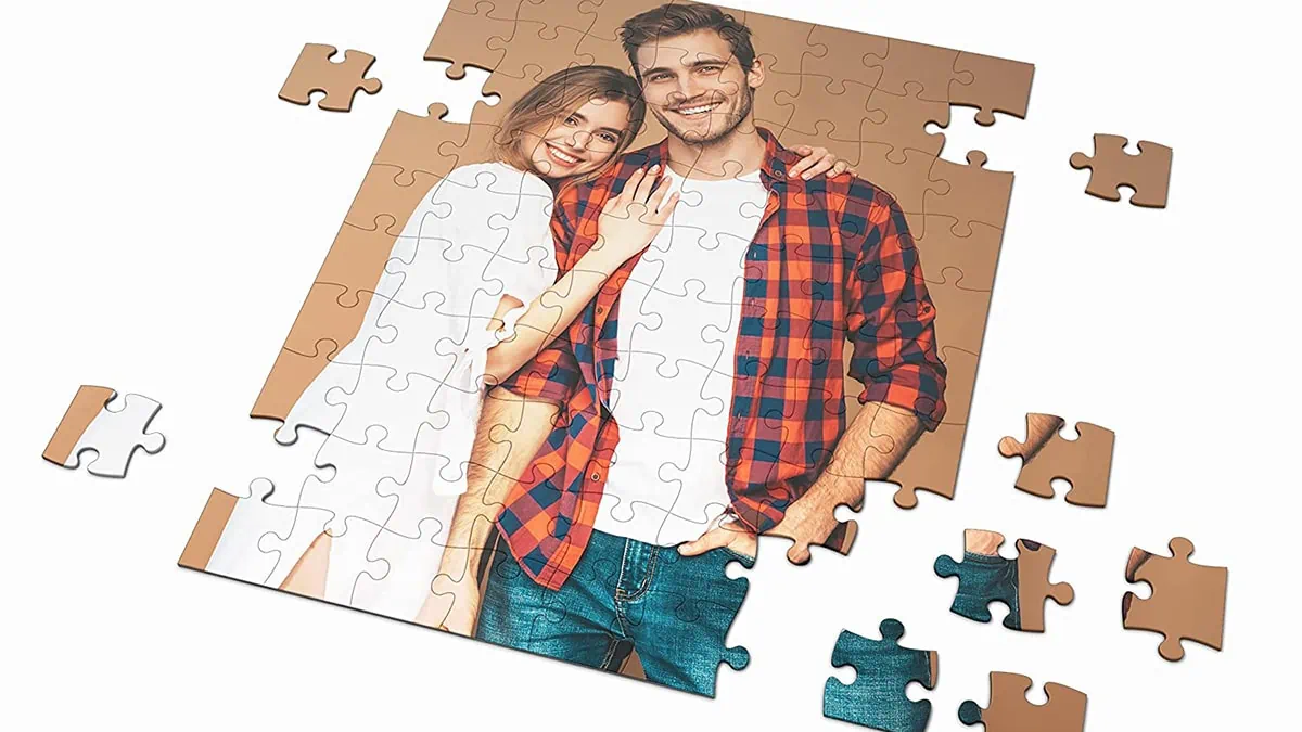 A personalized photo puzzle with a couple picture and few pieces shattered around 