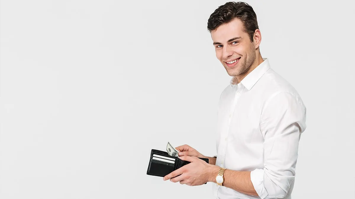 Man smiling with wallet in hand