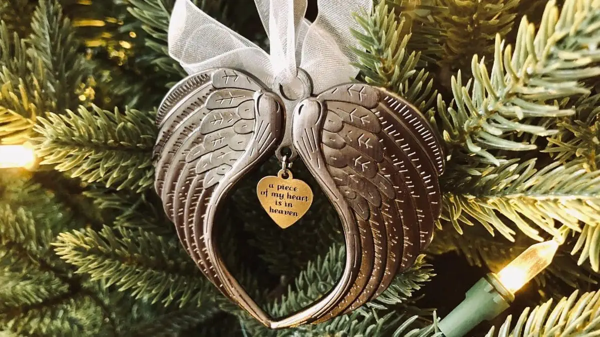 A Christmas ornament with a quote on it for a memorial gift to someone who has lost a sister.