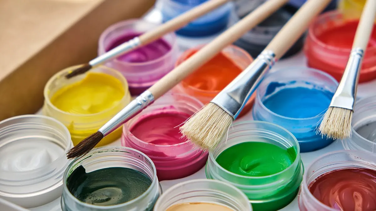 different color paints with a number of paintbrushes