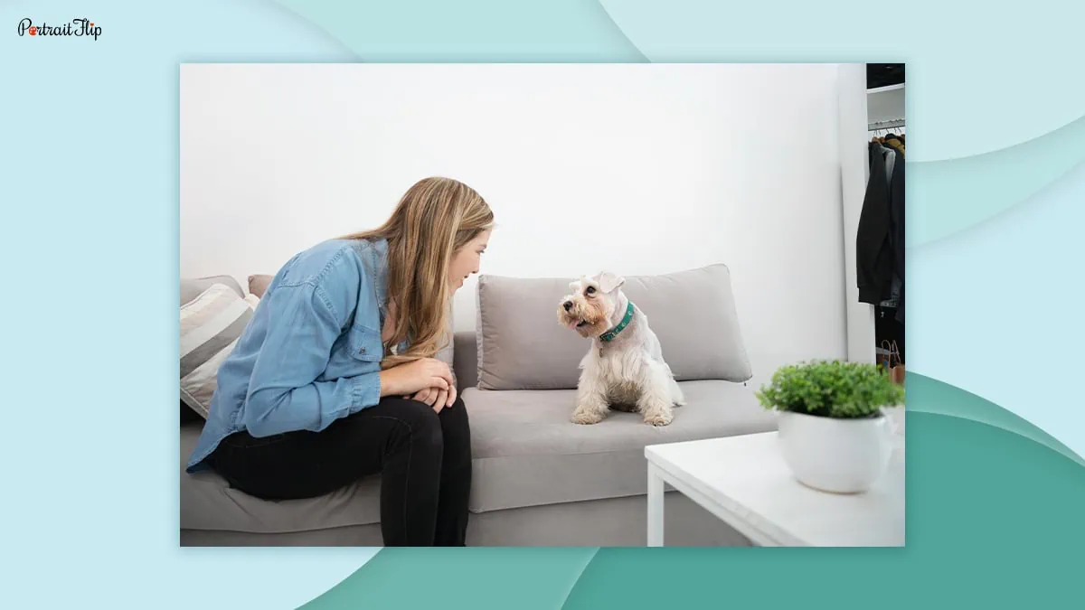 A woman is talking to a dog