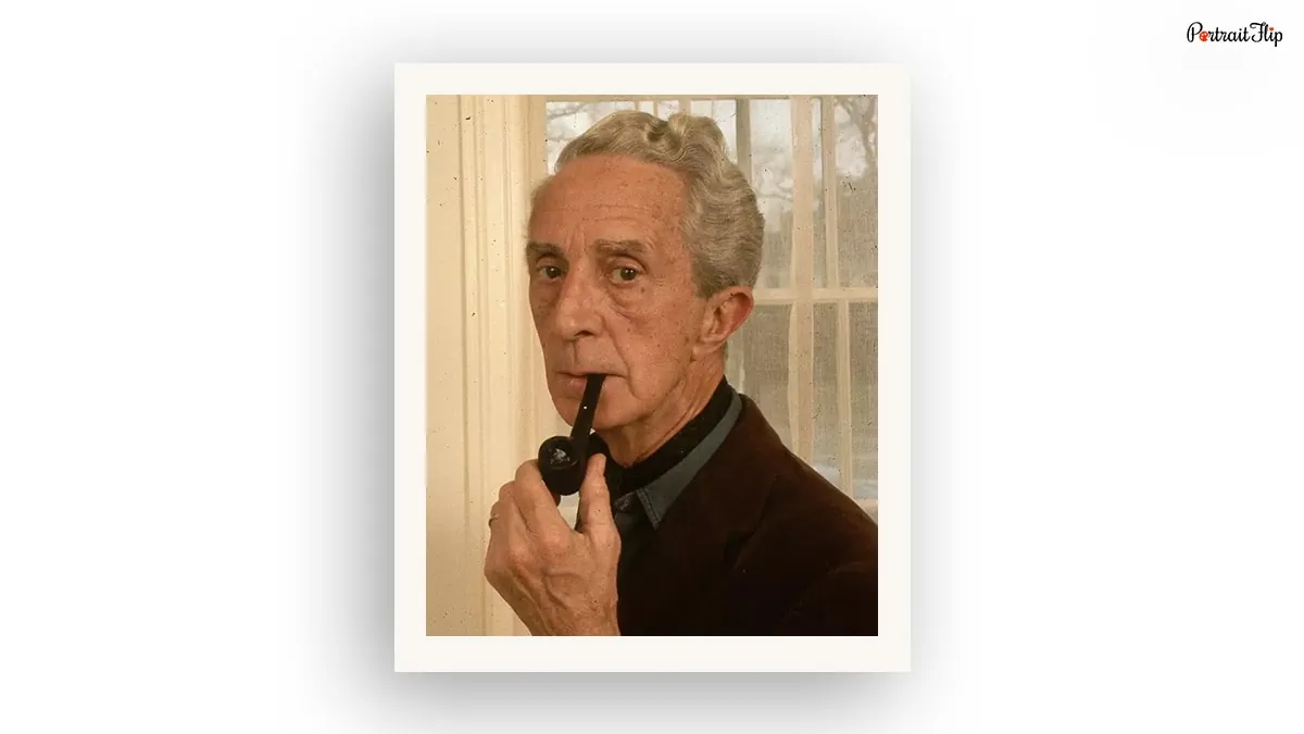 a photo of Norman Rockwell, an American artist holding a pipe in his mouth
