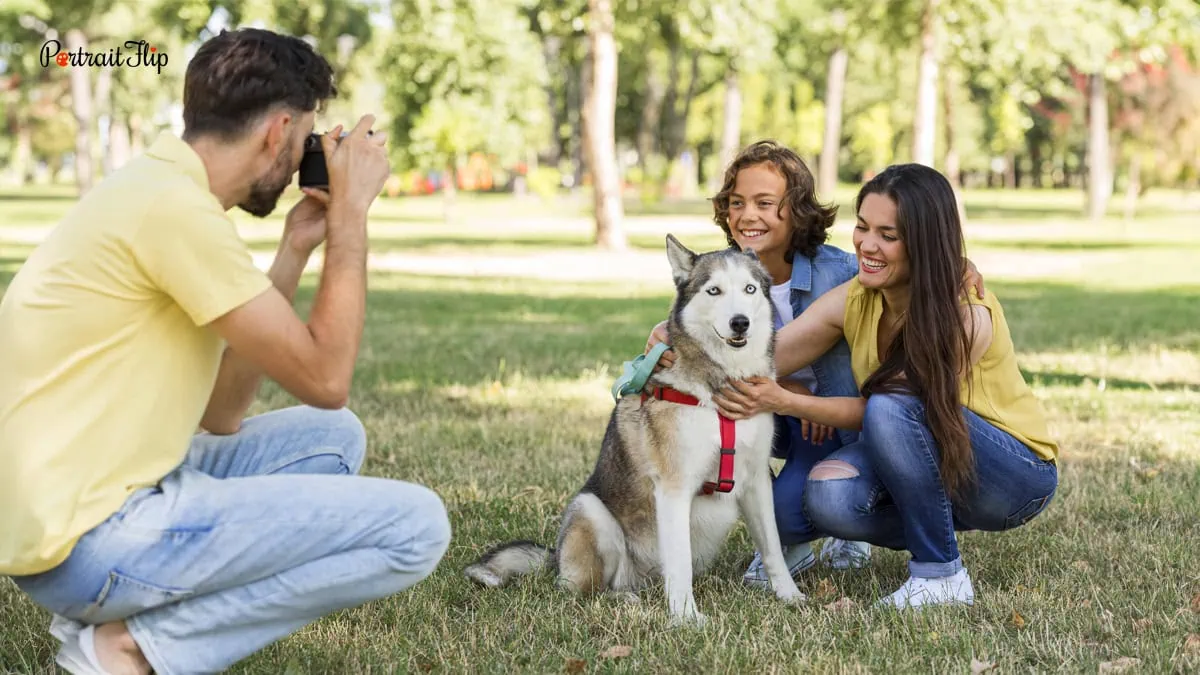 a family taking a photograph with their dog