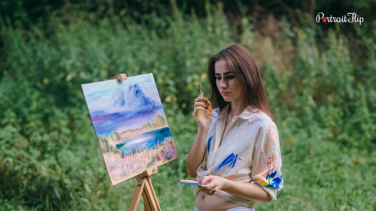 an artist thinking in front of her canvas