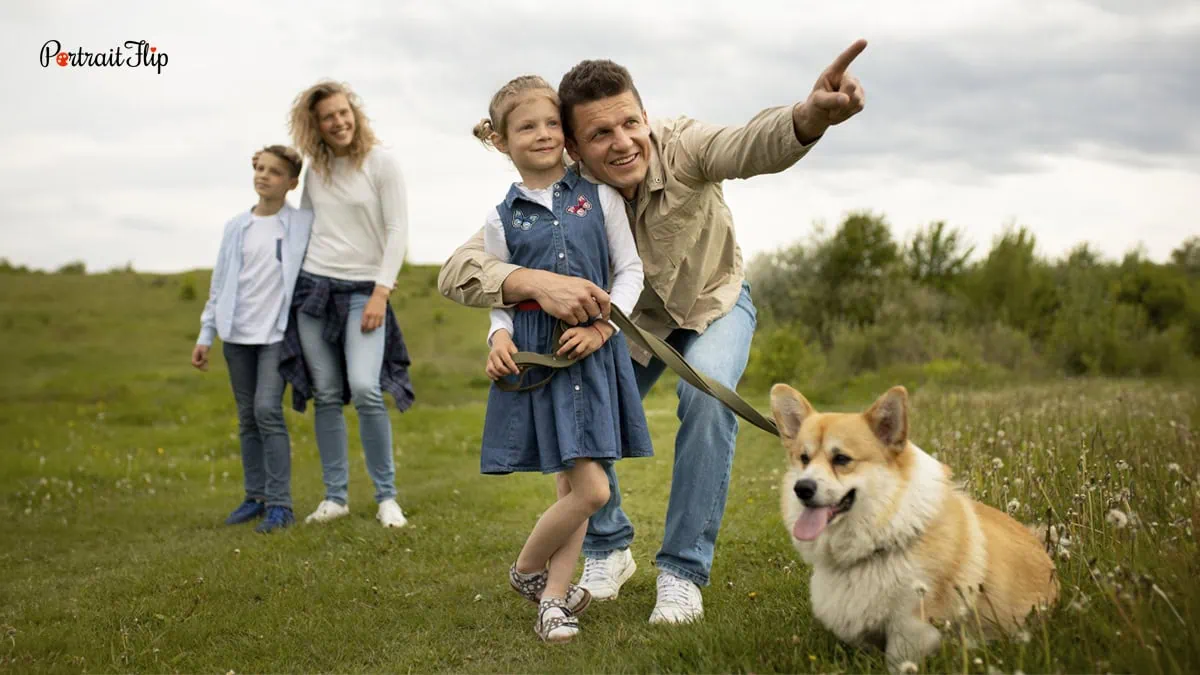 a family posing with their leashed dog