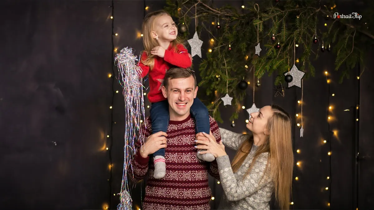 a happy family putting up christmas decoration