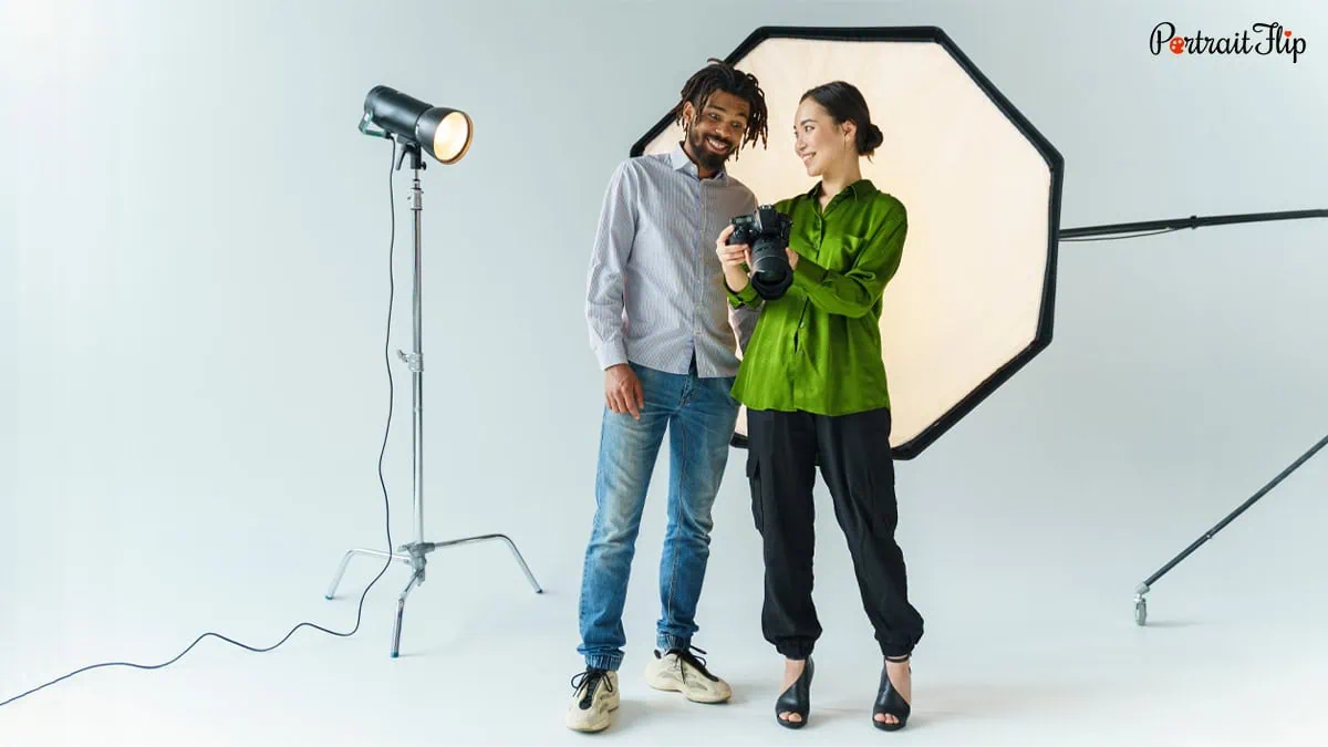 a photographer with her model in a studio