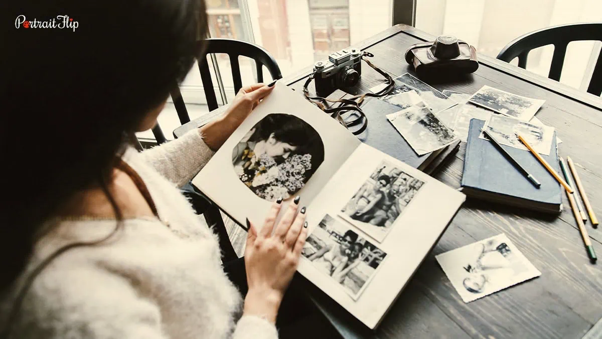 a woman looking through old photos 