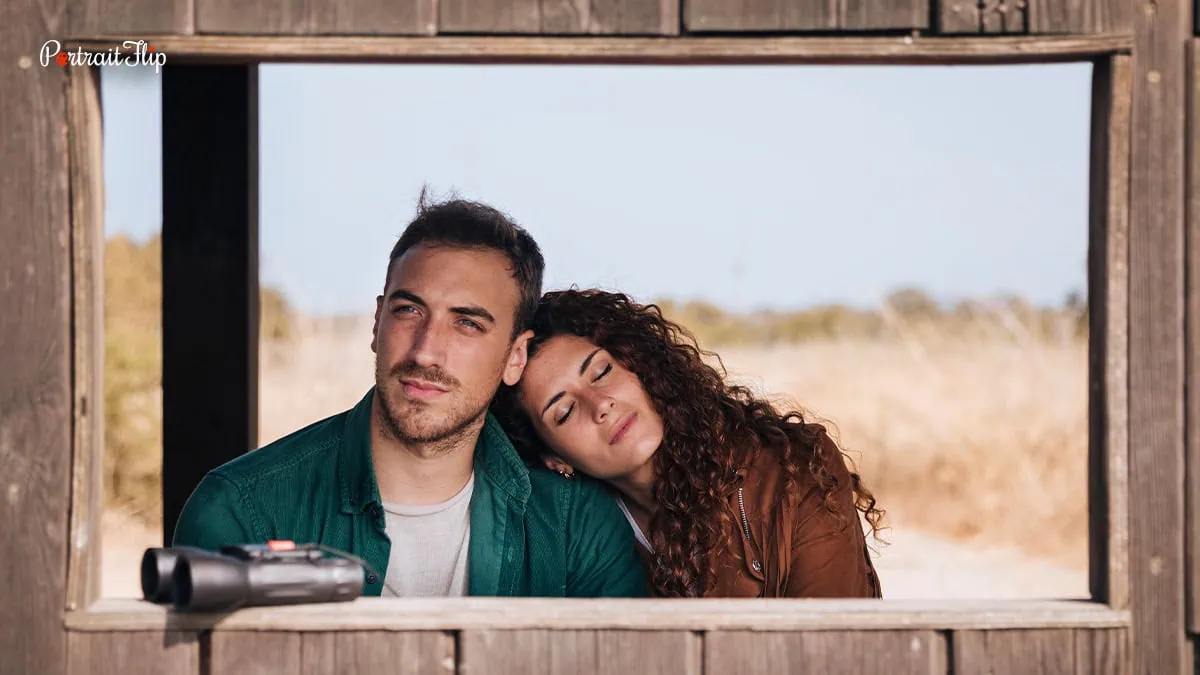 This image features a couple in a frame with the girl lying on the man's shoulder. 