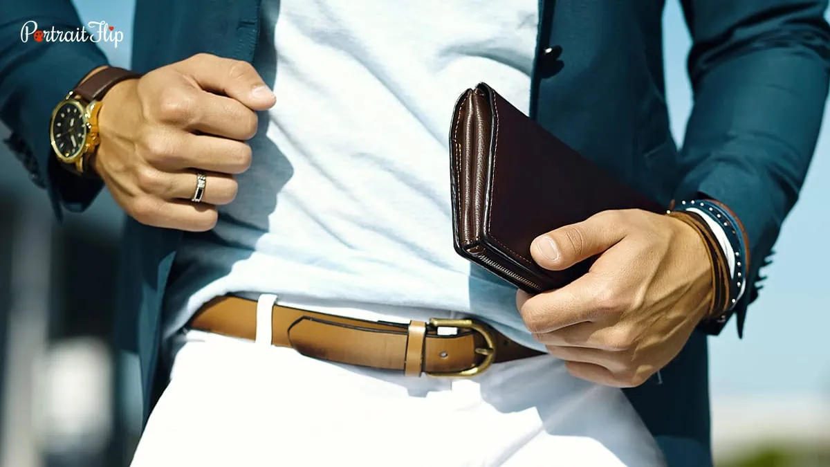 A man holding a wallet cum card holder