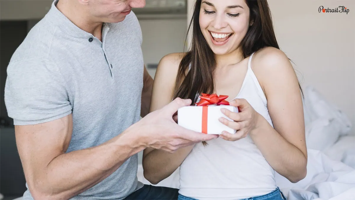 A man giving gift to a woman 